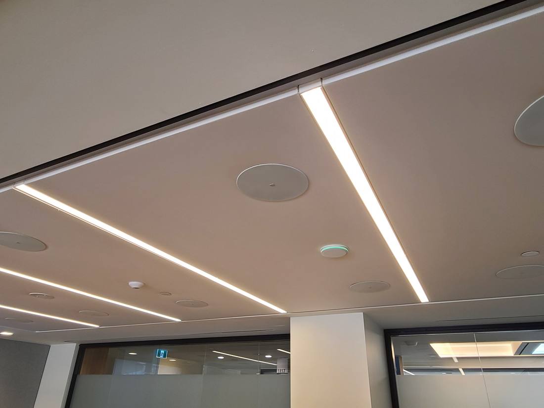 Linear LED ceiling detail with integrated speaker array