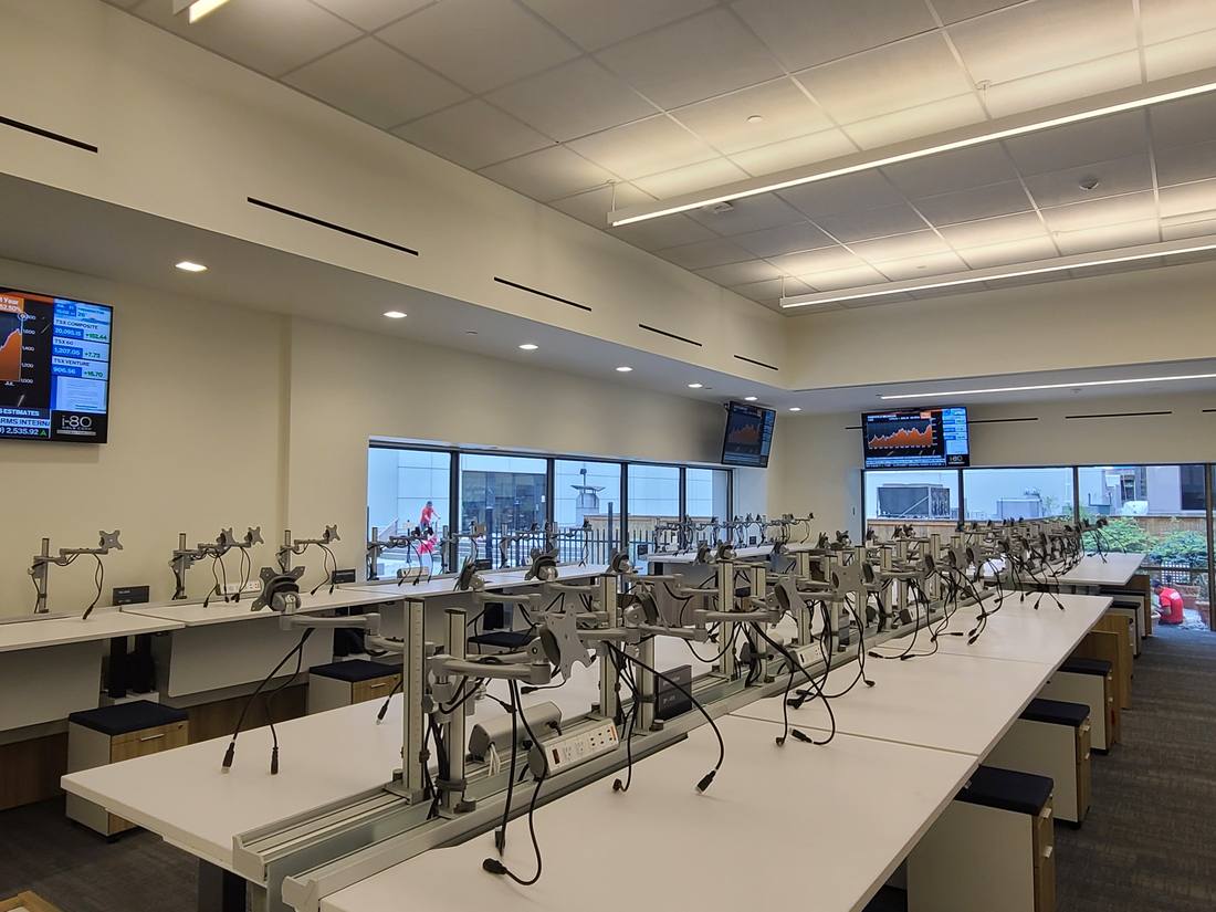 Trading floor with multi-monitor desks and market-data displays
