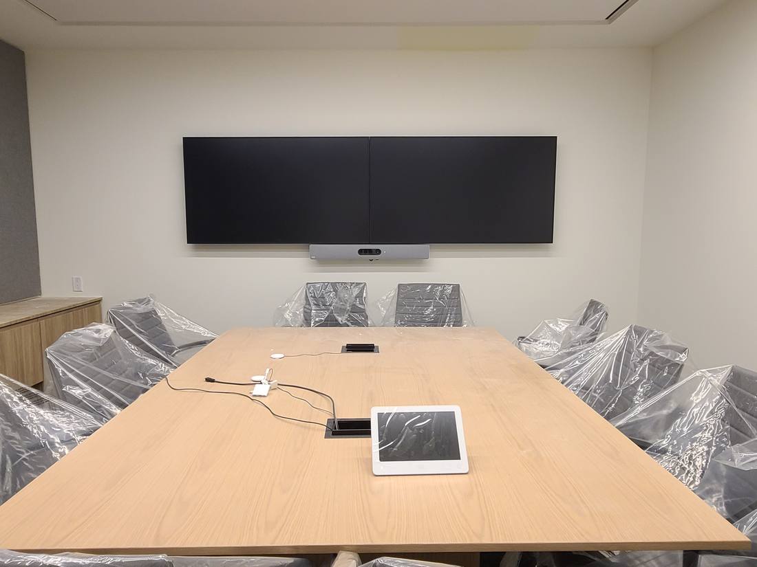 Finished boardroom with chairs wrapped in protective film