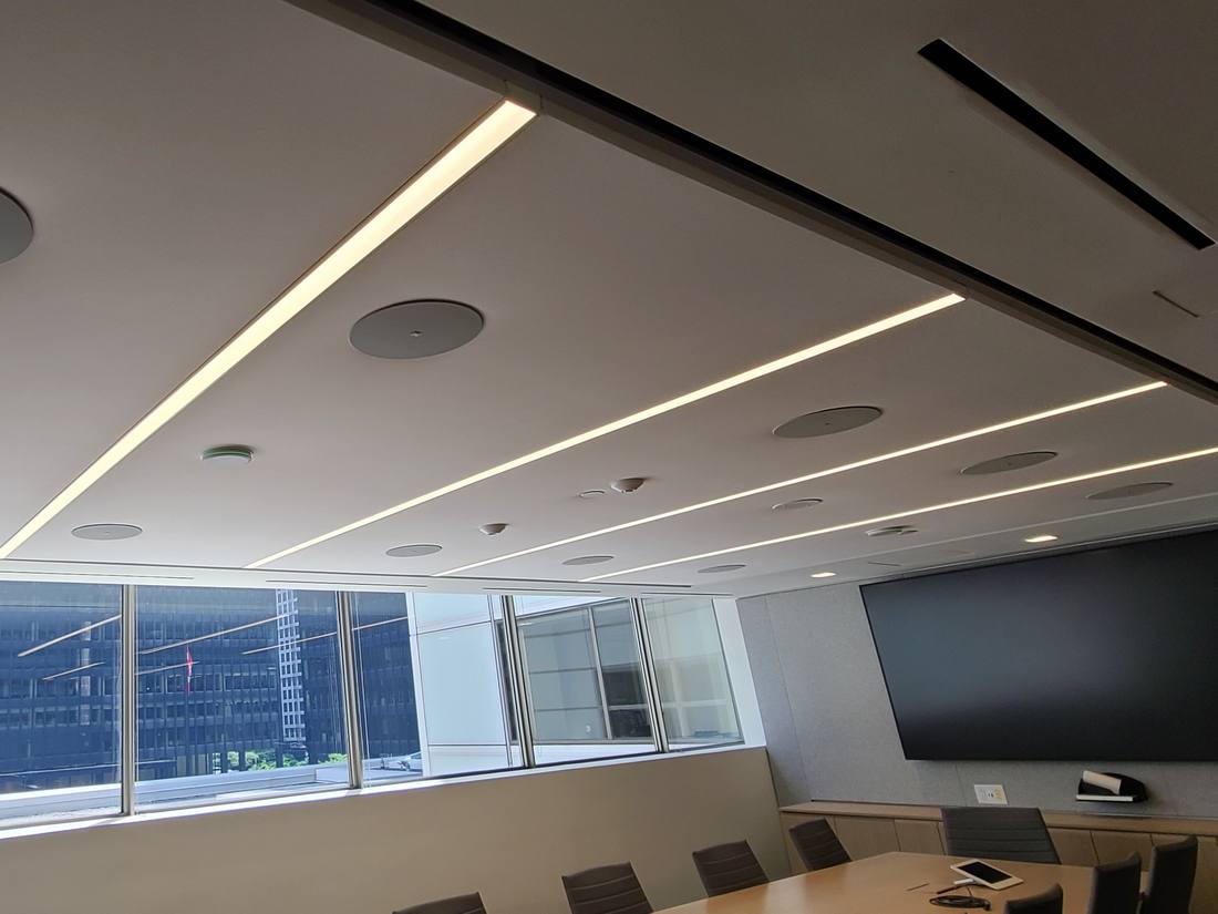 Ceiling AV detail leading toward a city-view boardroom