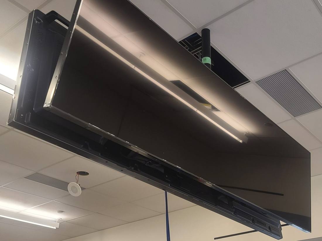 Ceiling ribbon display viewed at an angle during installation