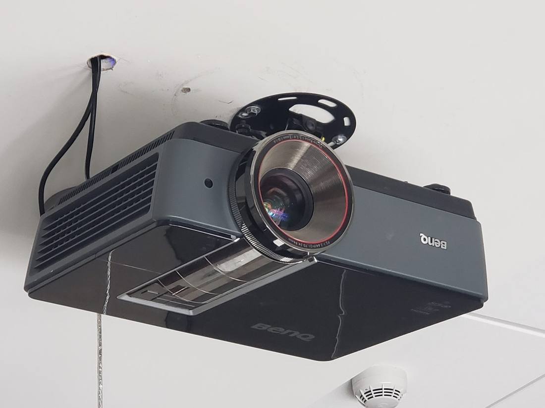 Ceiling-mounted projector on its mount, close-up