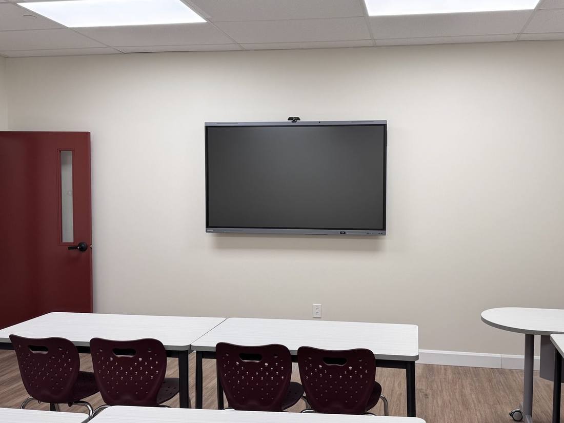 Finished classroom with smart board and rows of desks