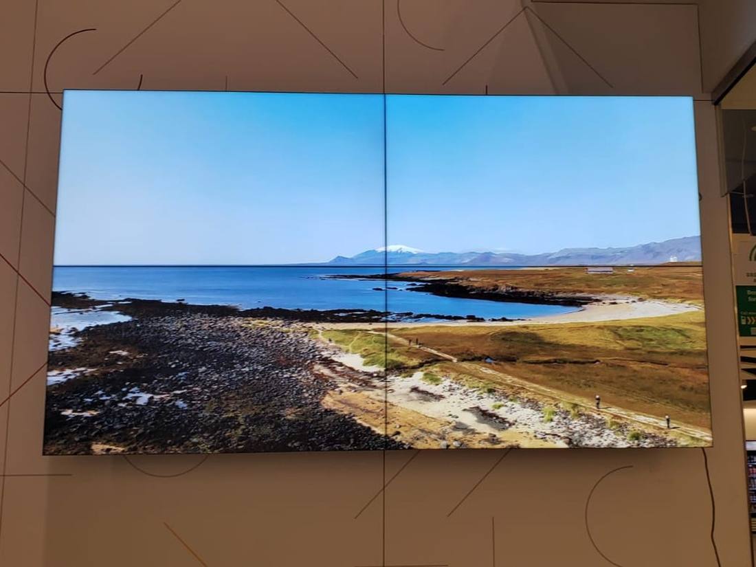 LED video wall showing a coastal scene in a lobby
