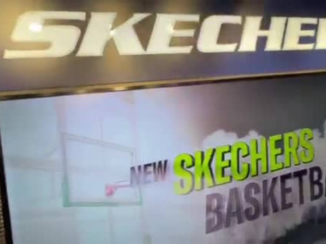 Curved LED video wall in a Skechers store showing basketball campaign content