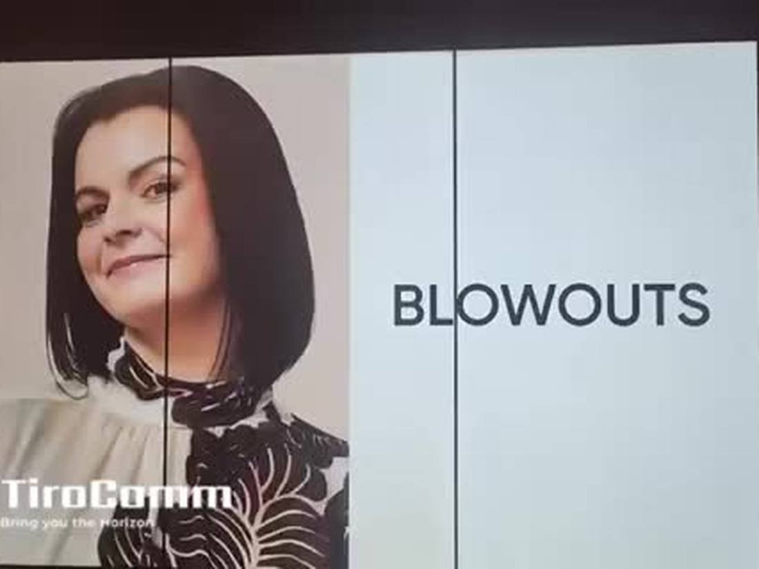 Multi-panel video wall showing salon service promotions